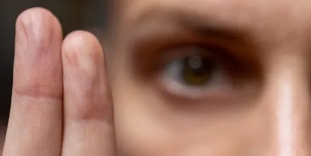 Close-up of EMDR bilateral stimulation — fingers guiding eye movement